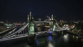 Establishing Aerial View Shot of London UK, United Kingdom, Tower Bridge at night, circling very close, Super clear image