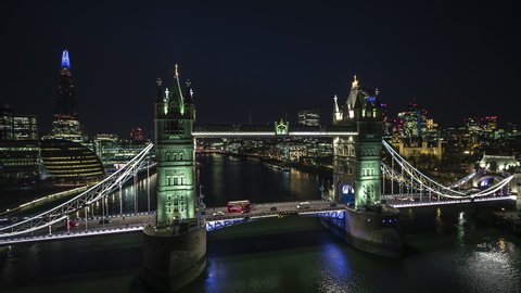 Establishing Aerial View Shot of London UK, United Kingdom, Tower Bridge at night, circling very close, Super clear image