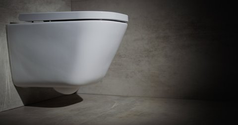Cinematic shot of Stylish white toilet bowl in a modern toilet.