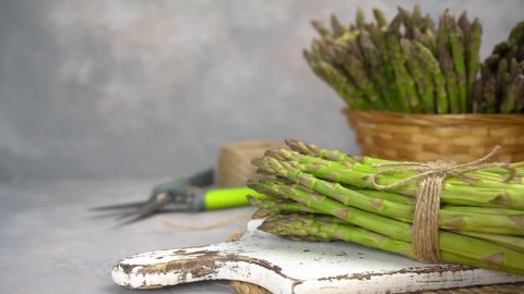 Asparagus. Fresh raw organic green Asparagus sprouts closeup. Basket and bunch n the table. Healthy vegetarian food. Raw vegetables, market. Healthy eating concept, diet, dieting.
