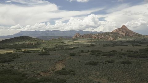 4K video of summer clouds above the Hop Valley in Zion National park Utah and clouds shadows passing across the landscape as seen from Hoodoo city.