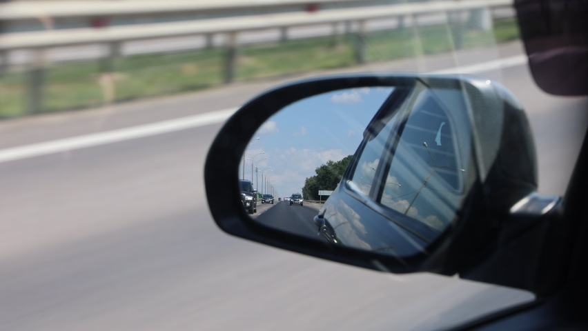 Rearview In The Side Mirror Of The Car, Overtaking Another Car. View From The Car. Royalty-Free Stock Footage #1085322155