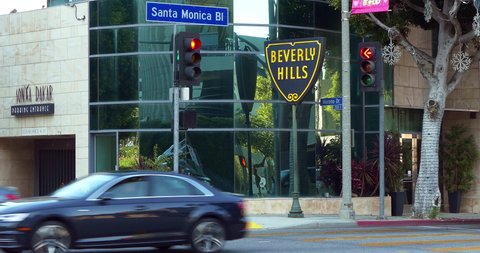 LOS ANGELES, CALIFORNIA, USA - JANUARY 4, 2022: Cars traffic on Santa Monica Boulevard near Beverly Hills city entrance sign close to Rodeo Drive in Los Angeles California, 4K