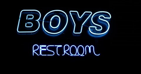 Boys Restroom bathroom blue neon sign on wall straight on wide angled shot as camera slowly zooms in with a whip pan transition - in Cinema 4k (30fps slowed from 60fps).
