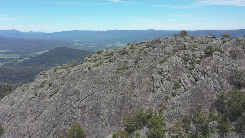 Beautiful orbiting aerial of Sugarloaf peak and green valley below