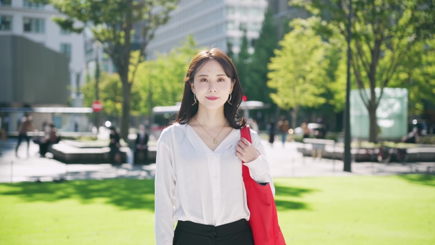 Young Asian woman smiling in the city. Royalty-Free Stock Footage #1085329595