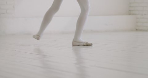 Teen girl wearing black leotard dancing. Young gymnast practicing moves and elements with clubs - childhood dream 4k footage