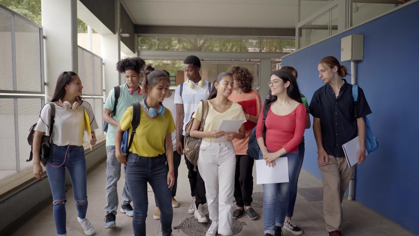 A group of students walk to the classroom to begin classes. Group of students at the high school. Multiethnic teenage people. Royalty-Free Stock Footage #1085332460