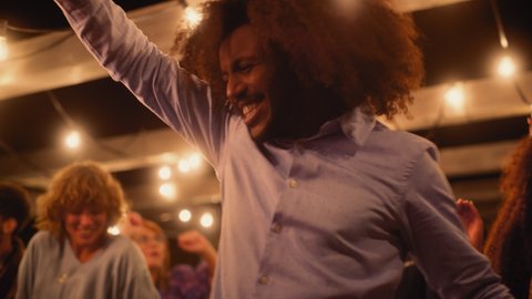 Close Up of Beautiful Carefree Friends are Dancing Together and Celebrating an Evening Event at a Party . Diverse Multiethnic Young Adult People Have Fun at a Corporate Party in a Restaurant.