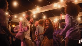 Beautiful Carefree Friends are Dancing Together and Celebrating an Evening Event at a Party . Diverse Multiethnic Young Adult People Have Fun at a Corporate Party in a Restaurant. - Powered by Shutterstock - Get 15% off with code: PIKWIZARD15