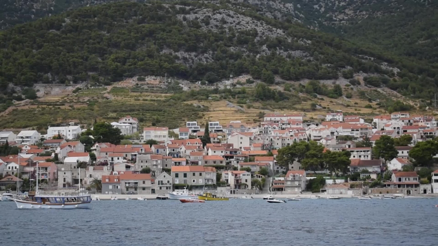 View of touristic place Bol on the island Brac in Croatia from a mooving boat