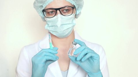 Doctor, nurse, scientist hand in blue gloves holding flu, measles, coronavirus, covid-19 vaccine.