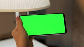 Female Hand Touch, Slide, Scroll, Drag Top Down of Green Screen of Horizontally Phone, Green Background, Chroma Key, Blank, Mockup, Close-up. Woman Uses Smartphone, Internet, Video Calling. 