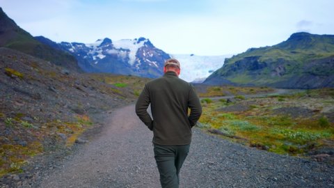 Male Tourist Walking On The Trail Near Svinafellsjokull Glacier In Vatnajokull, Iceland. following shot