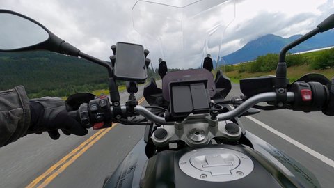 Homer , Alaska , United States - 12 17 2021: Motorbike traveling along scenic Road, Crossing Alaska on Road trip. Action cam Pov