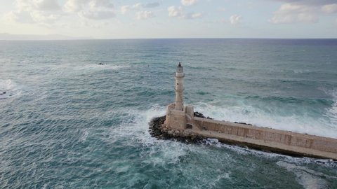 Epic Aerial Drone footage of lighthouse in the entrance of the picturesque old port of Chania. Cinematic shot. Accurate colors are perfect for colorgrading.