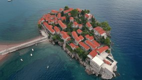 Aerial shot. Slowmotion video of the Sveti Stefan island. Famous tourist location near the city of Budva. Travel to Montenegro concept