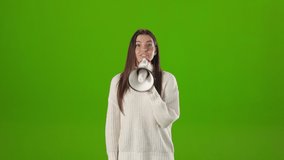 Positive caucasian woman in white knitted sweater using megaphone for announcing about hot news or advertising something. Chroma key studio wall on background. - Powered by Shutterstock - Get 15% off with code: PIKWIZARD15