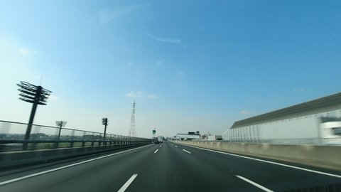Nagoya.Japan-October 31.2019: View from the car on the highway to Nagoya in Japan. Timelapse. Modern infrastructure. Fast transportation. Blue sky and amazing weather.