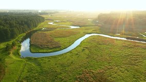 Gorgeous aerial footage of a winding river on a sunny day. Bird's eye view. Location place Polissya region, Ukraine, Europe. Cinematic drone shot. Filmed in UHD 4k video. Discover the beauty of earth.