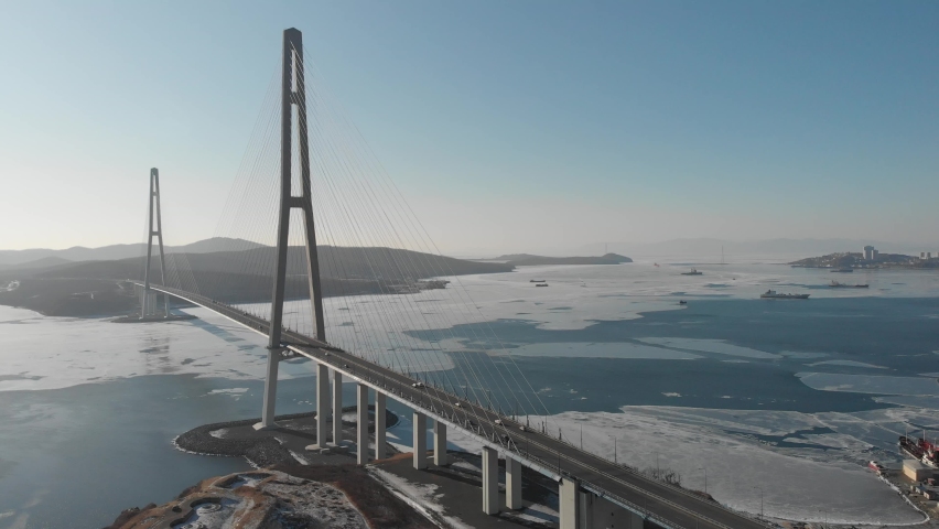 Flight on the longest cable-stayed bridge in the world called Russian Bridge. Sunset over the cable-stayed bridge. View of the bridge from a bird