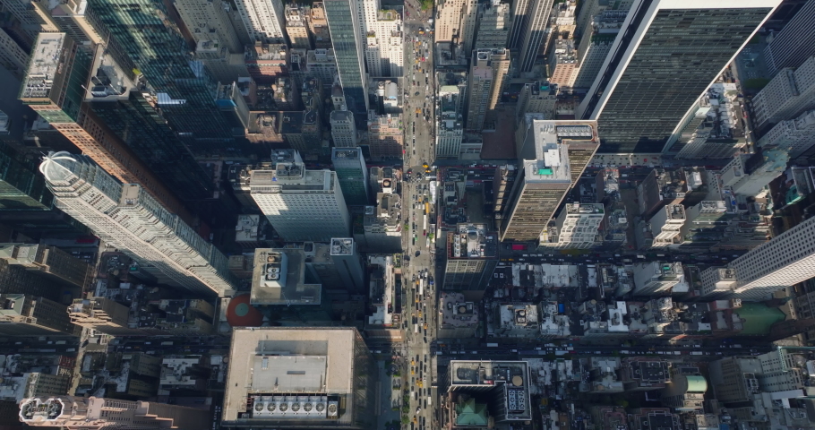Aerial birds eye overhead top down view of tall office of apartment buildings around 6th avenue. Heavy traffic in downtown streets. Manhattan, New York City, USA | Shutterstock HD Video #1085361164