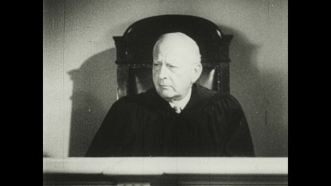 1930s: Judge speaks from bench. The Three Stooges testify and strangle each other, bop each other on the head, and put a head in a vise.