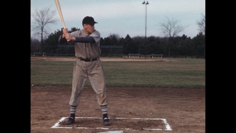 1940s: Baseball player standing at plate, swings bat. Player with bat, moves into bunting position.