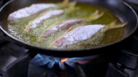 Roasted delicious red mullet fish cooked in an oiled pan 