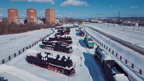 4K Aerial Footage of the Winter View to Old Steam Locomotives with the background to the snowy Nizhny Novgorod city, Russia