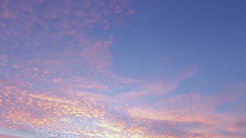 Colorful sunrise or twilight sunset on beautiful pastel blue sky with golden pink cloud n orange cirrocumulus cloudscape in tropical summer sunlight n sun ray at dusk or dawn view, 4k b-roll TimeLapse Royalty-Free Stock Footage #1085365451