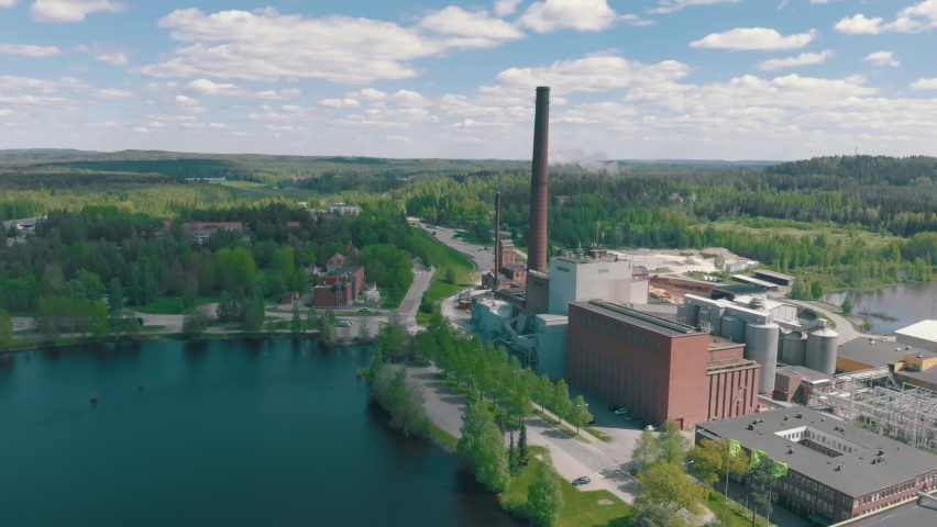 Sunny drone shot of MetsäTissue paper mill in Mänttä, Finland. Tissue and paper production in the wooded Northern Europe.