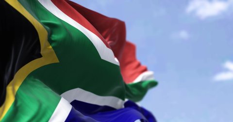 Detailed close up of the national flag of South Africa waving in the wind on a clear day. Democracy and politics. African country. Selective focus. Seamless Slow motion