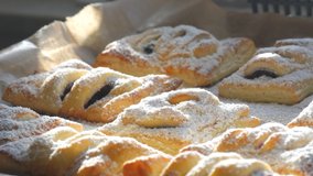 Delicious homemade cakes. Puff pastry with cherries, generously sprinkled with icing sugar on top. Delicious fresh buns close up view - Powered by Shutterstock - Get 15% off with code: PIKWIZARD15
