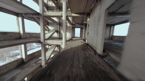 FPV drone flies maneuverable through an abandoned building. Post-apocalyptic location without people