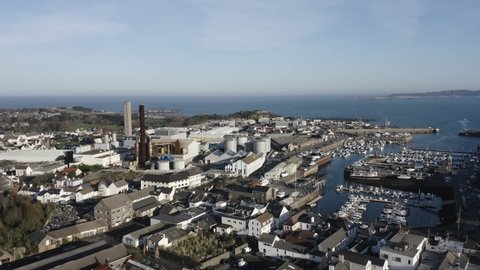 Flight from Leale’s yard towards vale Castle Guernsey including the Bridge,St Sampson, Marina, harbour,power station, M and G boatyard, Quayside,Northside and commercial wharf on calm sunny day
