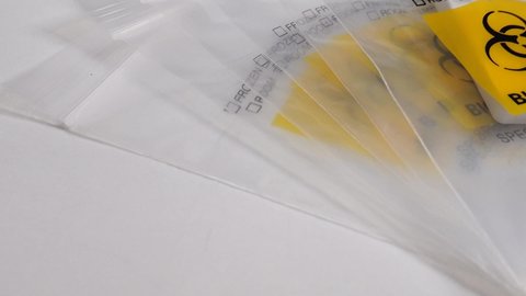 A biohazard plastic bag and a Covid-19 self test. 
