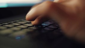Typing hands in closeup 4k video. Person working on laptop computer at night. Macro stock footage of man doing distant work online with notebook pc