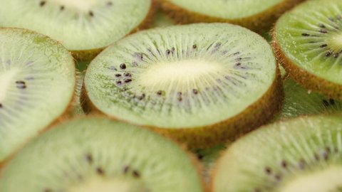 Kiwi fruit. Camera slowly pans down to show macro shot of fresh juicy sliced kiwi fruit