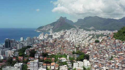 Aerial view Rio de Janeiro Brazil. Cityscape with a mountain landscape on the slopes of which are built favelas and new houses on the ocean with beaches.