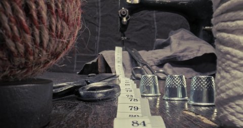 Small tailor workshop full of colorful thread on spools. Vintage weaving workshop.