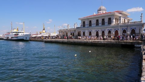 ISTANBUL - AUGUST 16, 2021: Many tourists arrived at Buyukada by regular ferry, get off the ship and walk ashore by quay in front of ferry port building. A hot summer day in Istanbul.