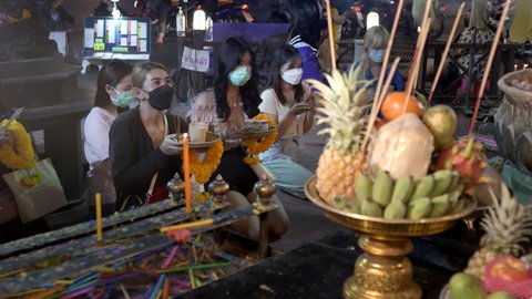 Group of Asian young woman praying, worship to Ganesh God for love and luck. Holding joss stick offer food. Ganesh Shrine, Huai Khwang, 10bit, 422. Bangkok, Thailand Nov 15 2021