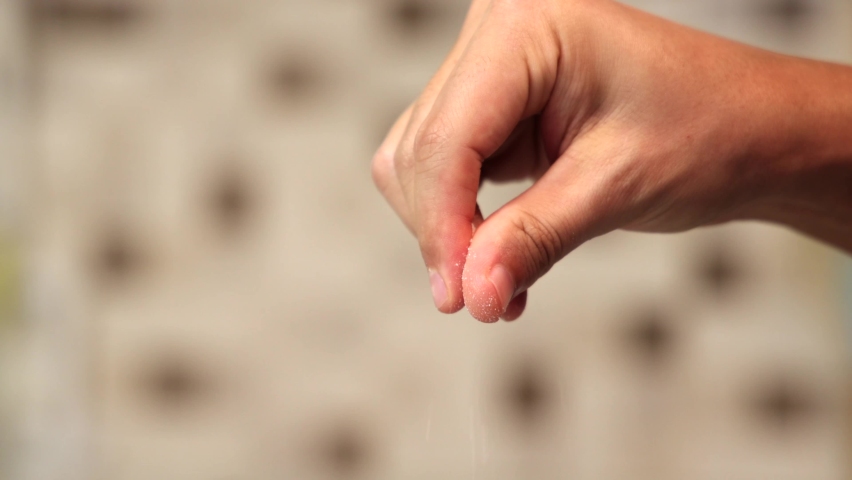Close up view of hands sprinkle a salt. Blurred background. 4k, slow motion Royalty-Free Stock Footage #1085401106