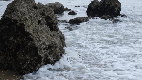 the stone is half in the water on the beach of zanzibar