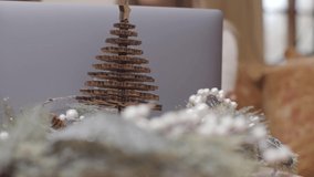 Extreme Close Up of Christmas Table Decorations In Front of Couple Using a Laptop . High quality video