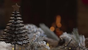 Extreme Close Up Shot of Table Christmas Ornaments In Front of Cosy Fireplace. High quality video