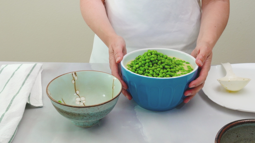 Creamy pureed celery soup with fresh green peas recipe, mixing ingredients in a bowl