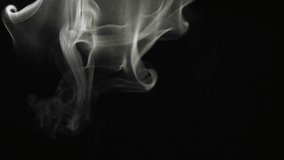 Smoke from top to bottom. Cloud of cold fog on black background. Realistic smoke best for using in composition, steam over black background. 4K UHD video footage 3840X2160.