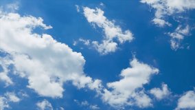 Time lapse clouds in blue sky, fast moving, sunny weather motion, Seamless Loopable, Towering Cumulus Billows, Loop features puffy white fly over a deep blue skies. 4K.